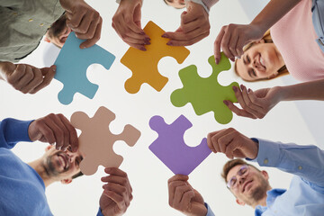 People holding puzzles to specify the idea