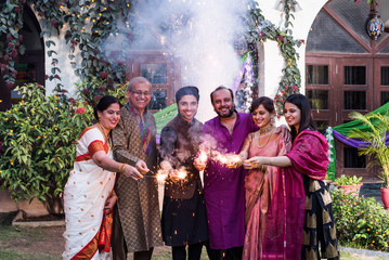 A family burning crackers and celebrating the diwali event